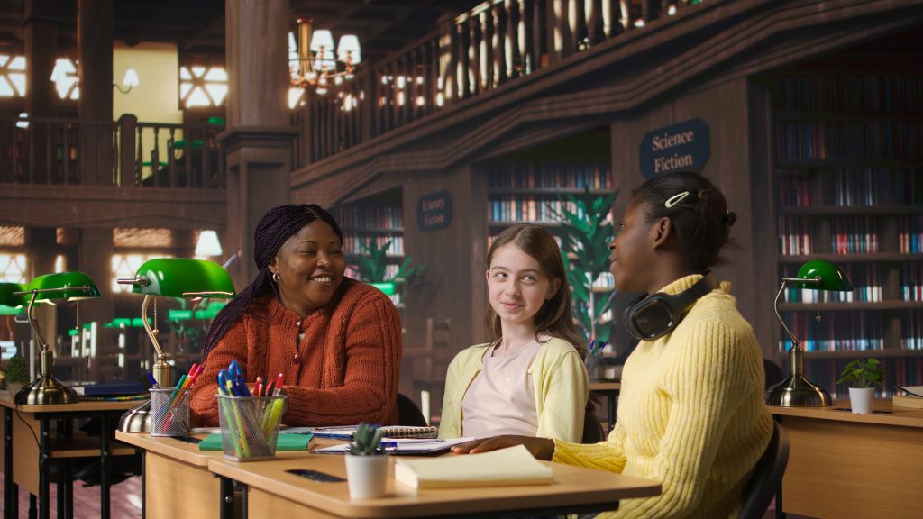 diverse teen girls working with a tutor to complete class notes in a library